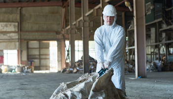 Worker cleaning industrial area